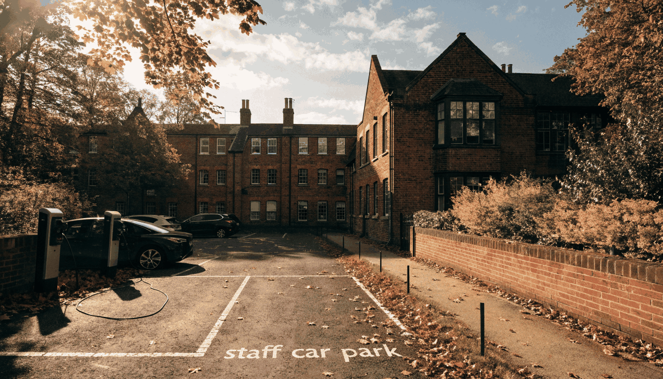 School staff car park with EV chargers on an autumn morning